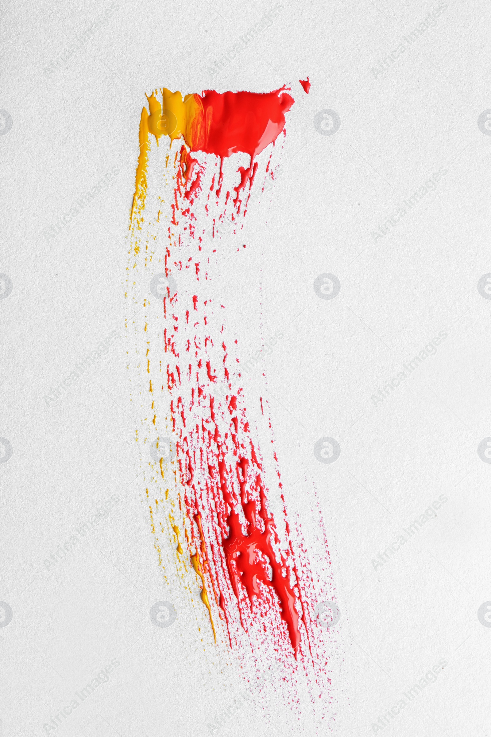 Photo of Abstract brushstroke of mixed color paint isolated on white