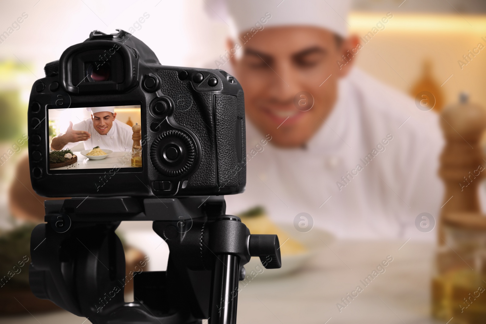 Image of Food photography. Shooting of chef with dish, focus on camera
