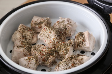 Photo of Delicious chicken with spices in modern multi cooker, closeup