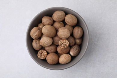 Photo of Nutmegs in bowl on light table, top view