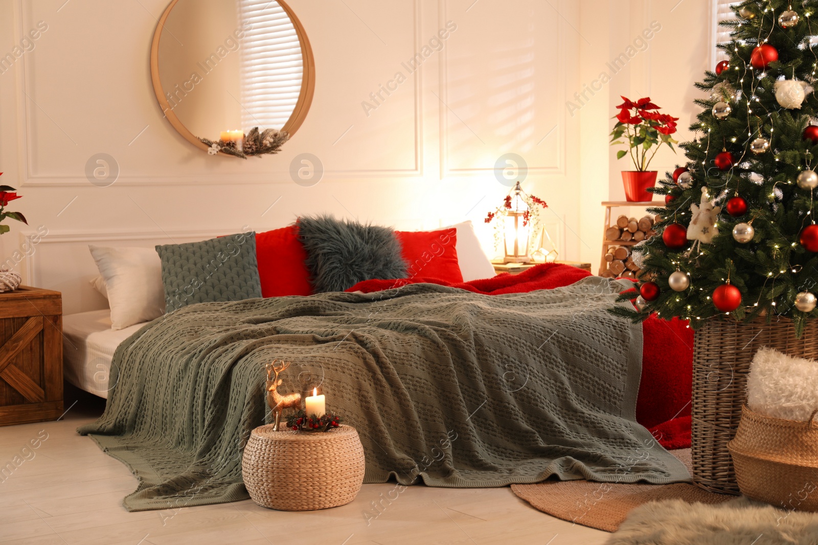 Photo of Beautiful decorated Christmas tree with fairy lights in bedroom. Interior design