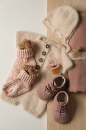 Photo of Baby clothes, shoes and accessories on light background, flat lay