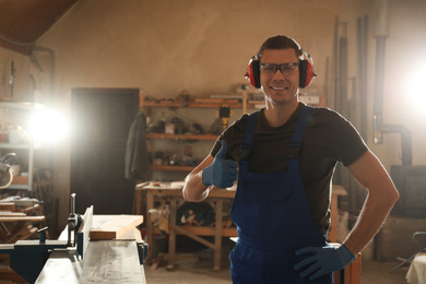 Portrait of professional male carpenter in workshop