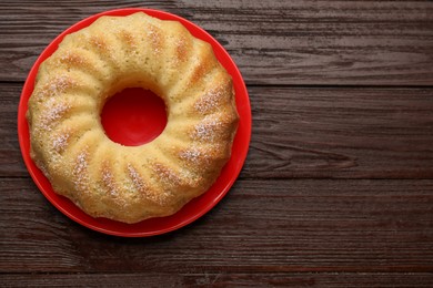 Photo of Delicious freshly baked sponge cake on wooden table, top view. Space for text