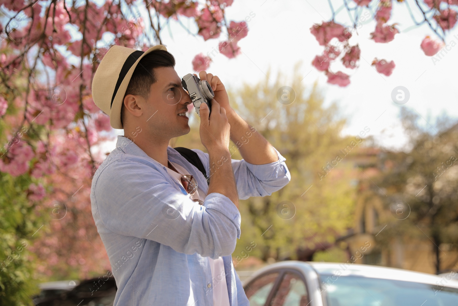 Photo of Tourist taking picture on beautiful city street