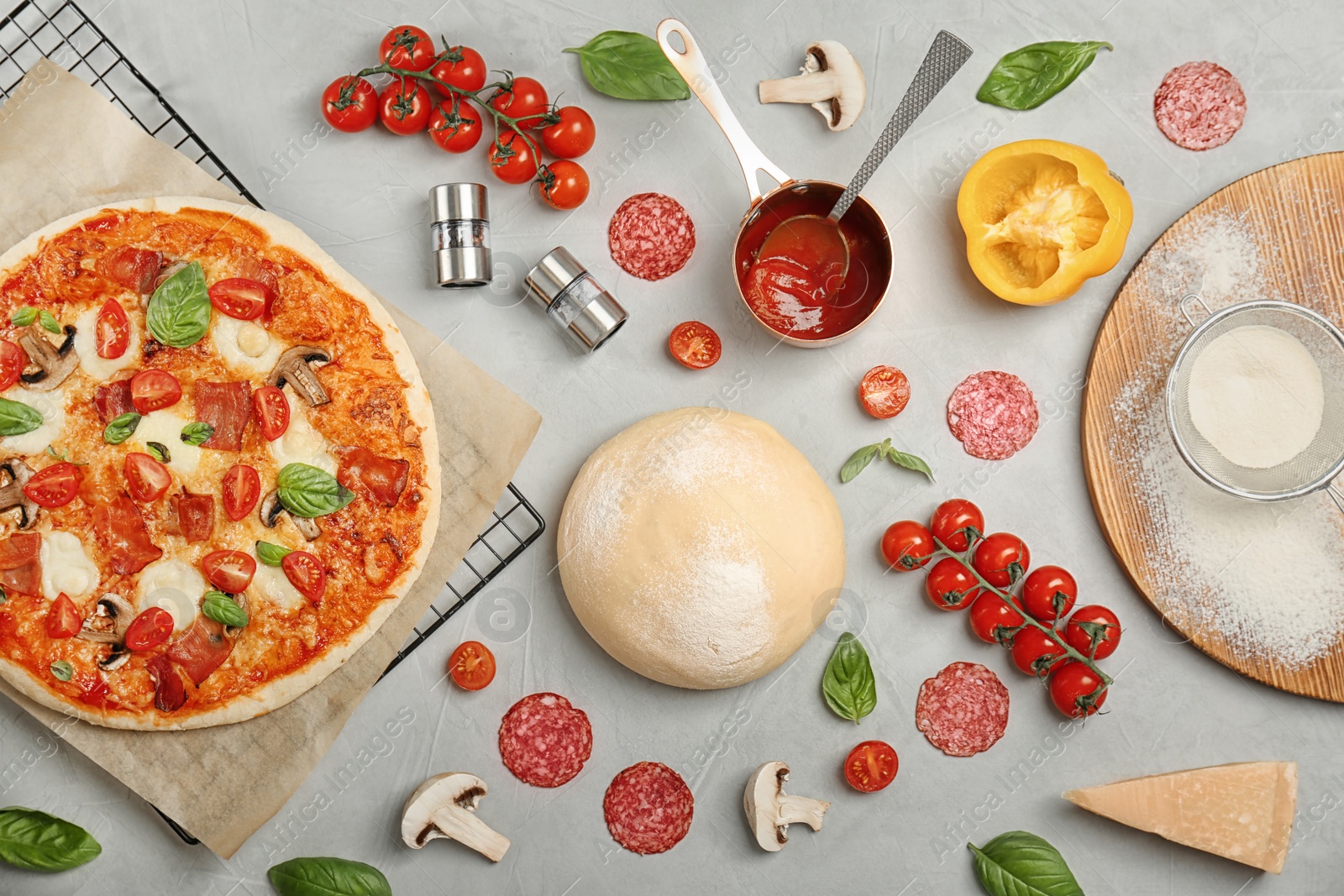 Photo of Composition with delicious pizza and ingredients on table, top view