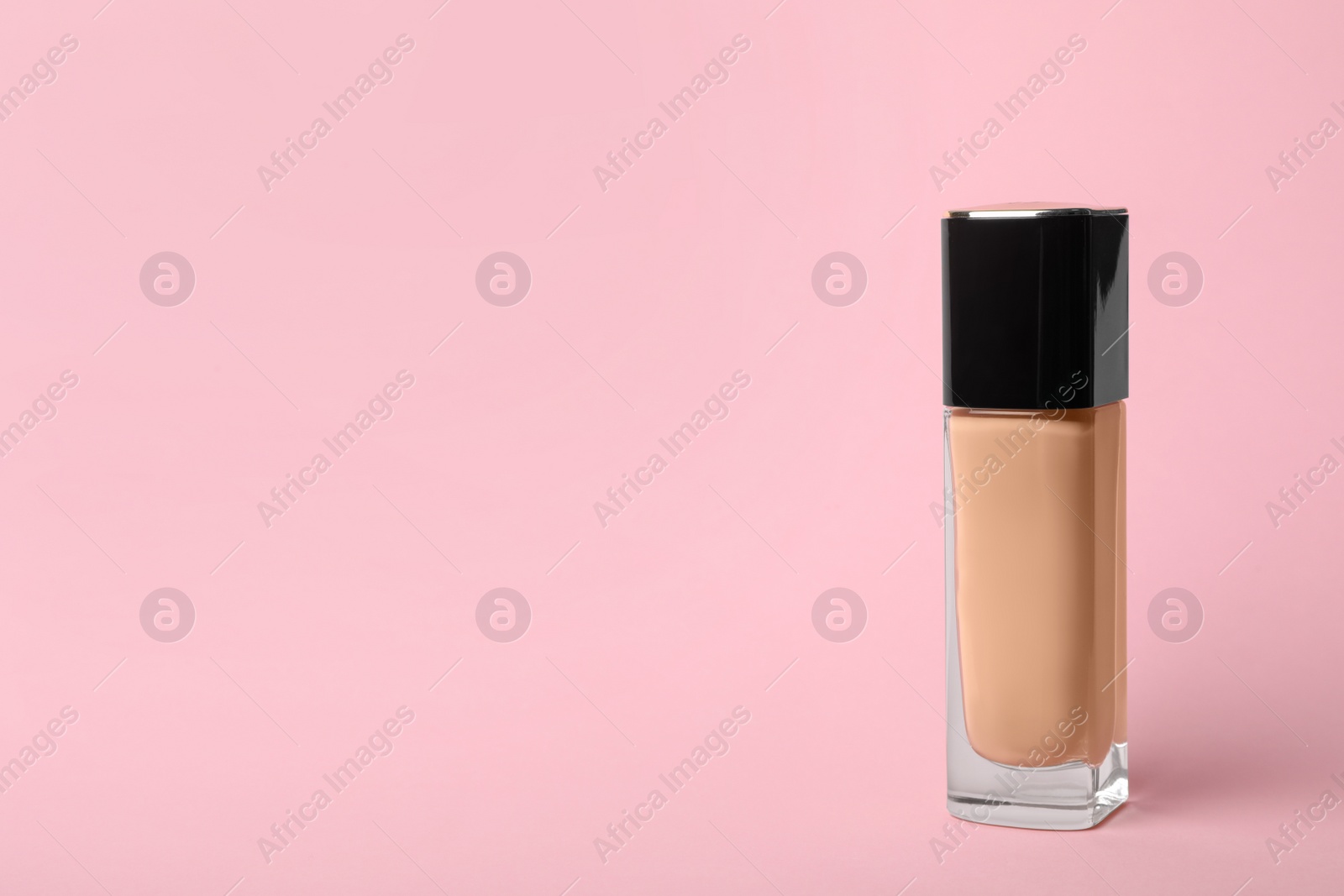 Photo of Bottle of skin foundation and space for text on color background