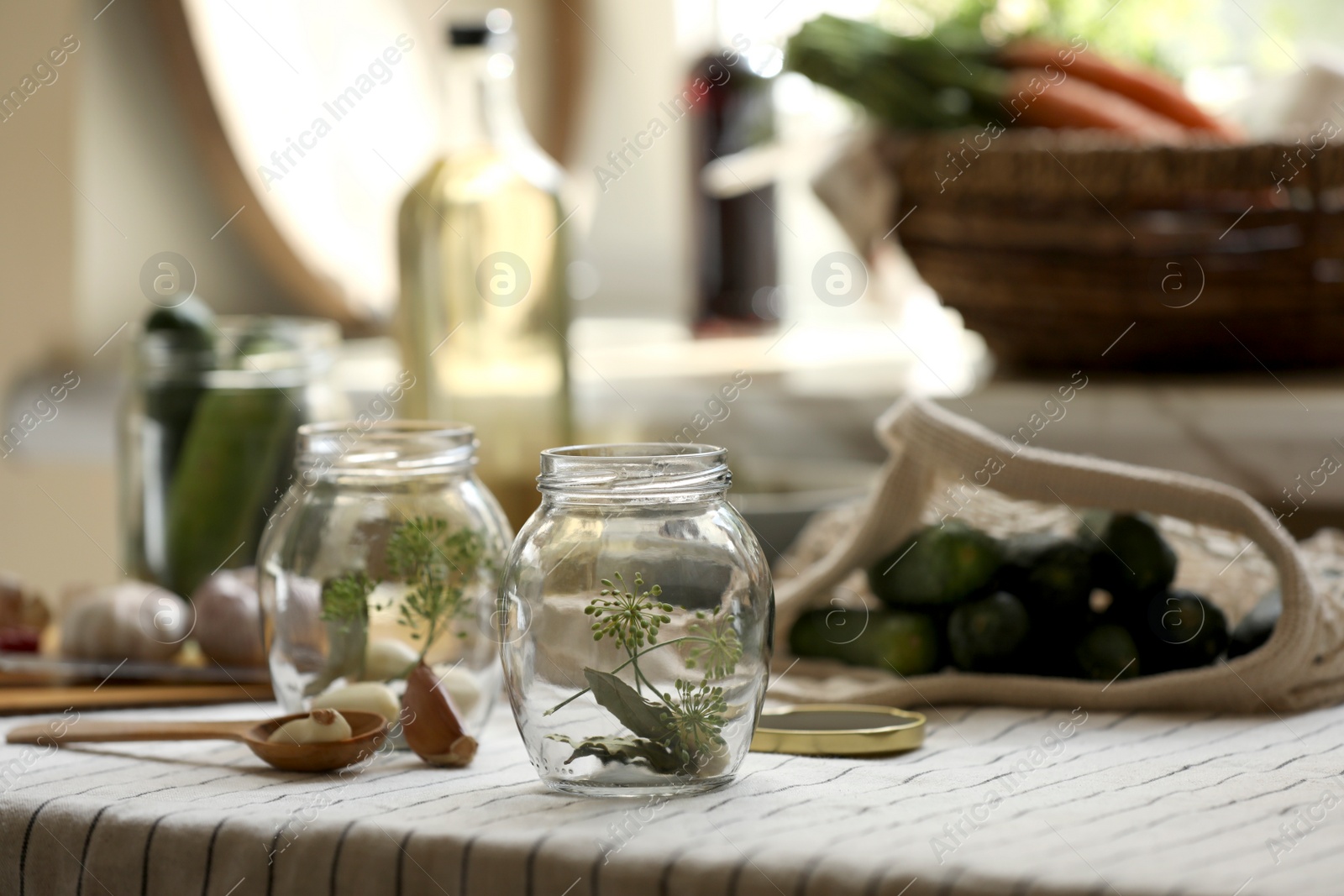 Photo of Empty glass jars and ingredients prepared for canning on table. Space for text