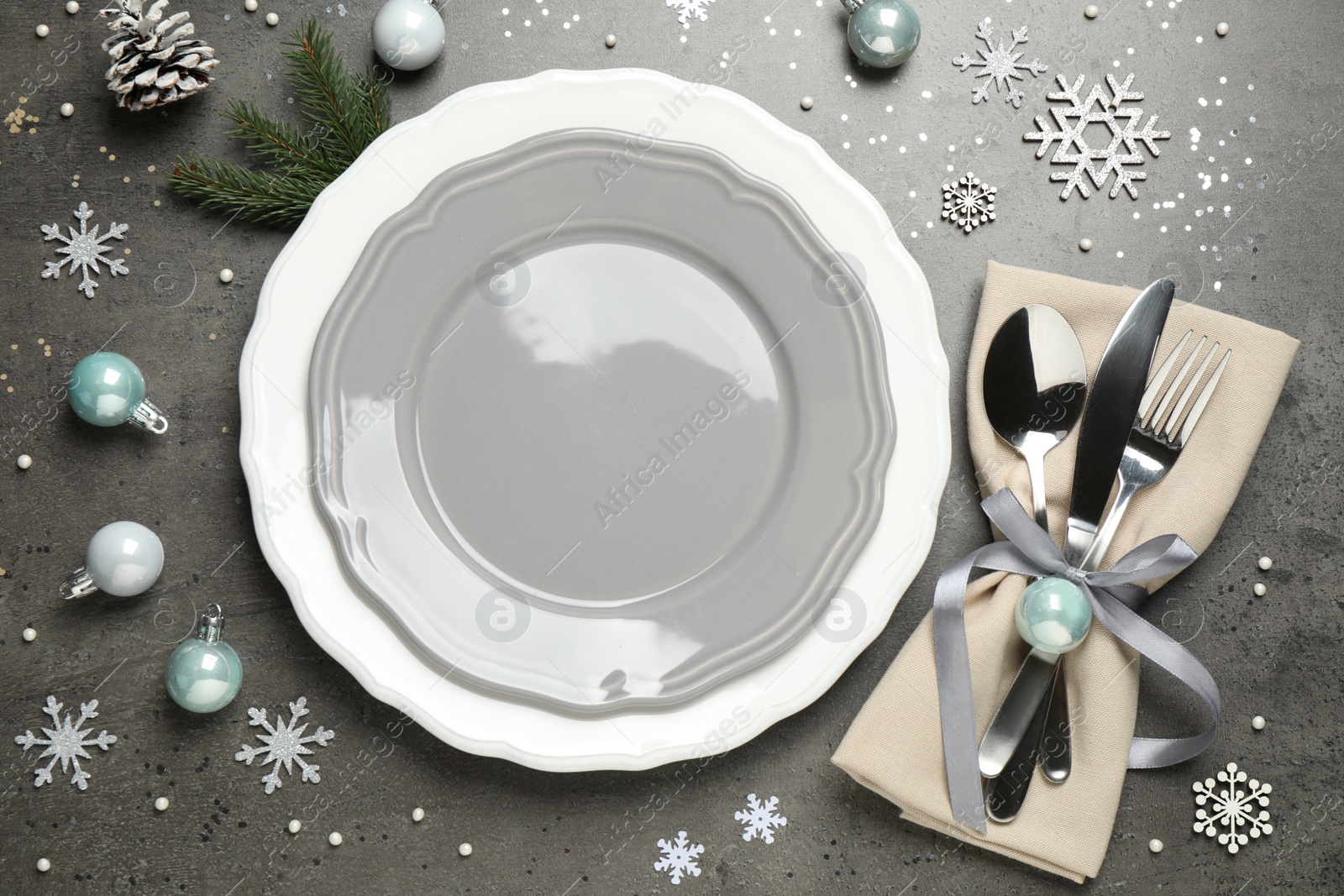 Photo of Beautiful Christmas table setting and festive decor on grey background, flat lay