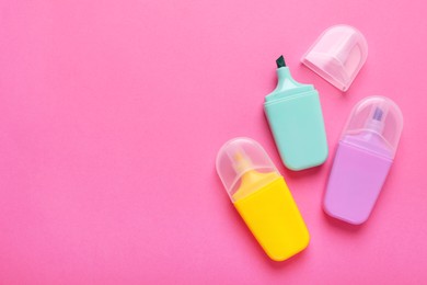 Photo of Many colorful markers on pink background, flat lay. Space for text