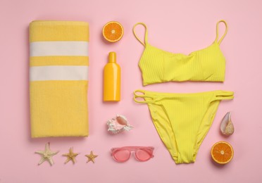 Flat lay composition with beach objects on pink background