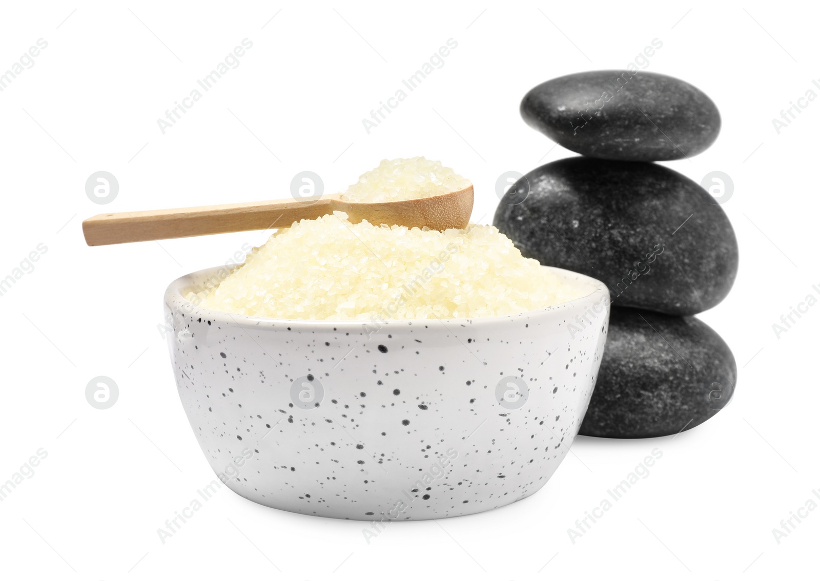 Photo of Sea salt in bowl, spoon and spa stones isolated on white
