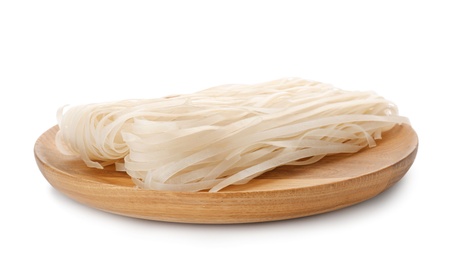 Wooden plate with raw rice noodles on white background