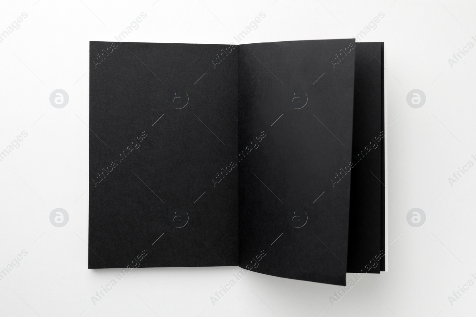 Photo of Blank black sketchbook on white background, top view