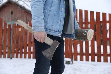 Man with axe and wood outdoors on winter day, closeup