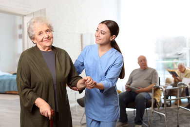 Photo of Nurse taking care of elderly woman in geriatric hospice
