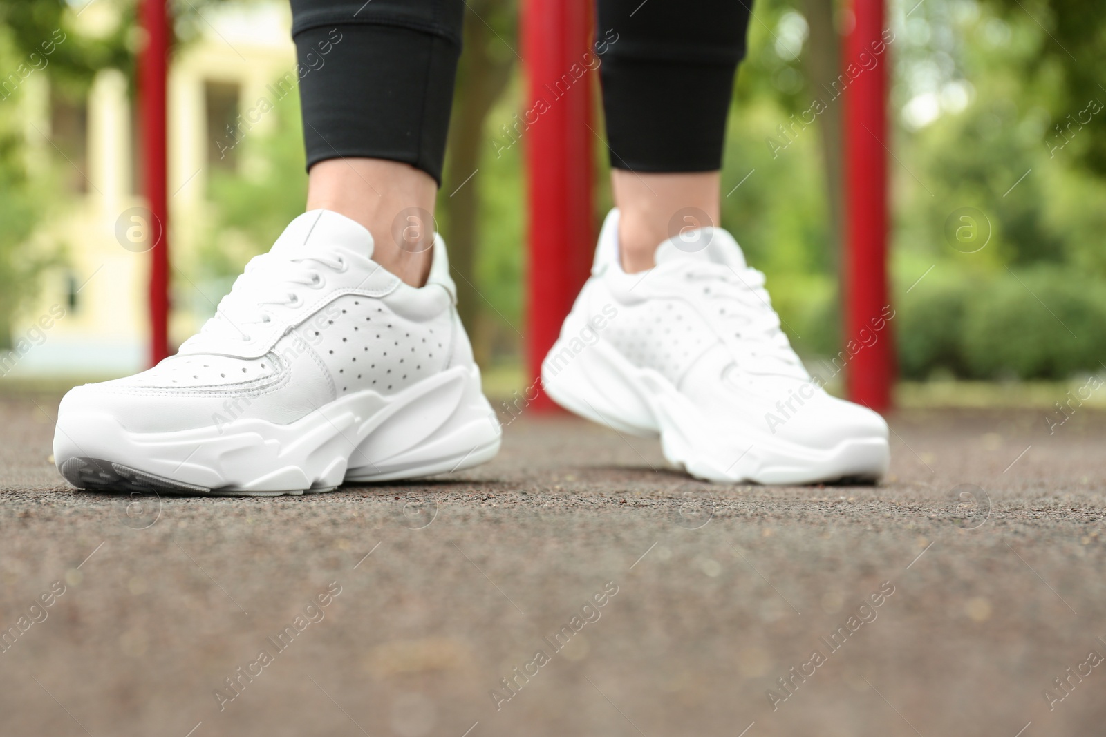 Photo of Woman in comfortable stylish sneakers outdoors, closeup