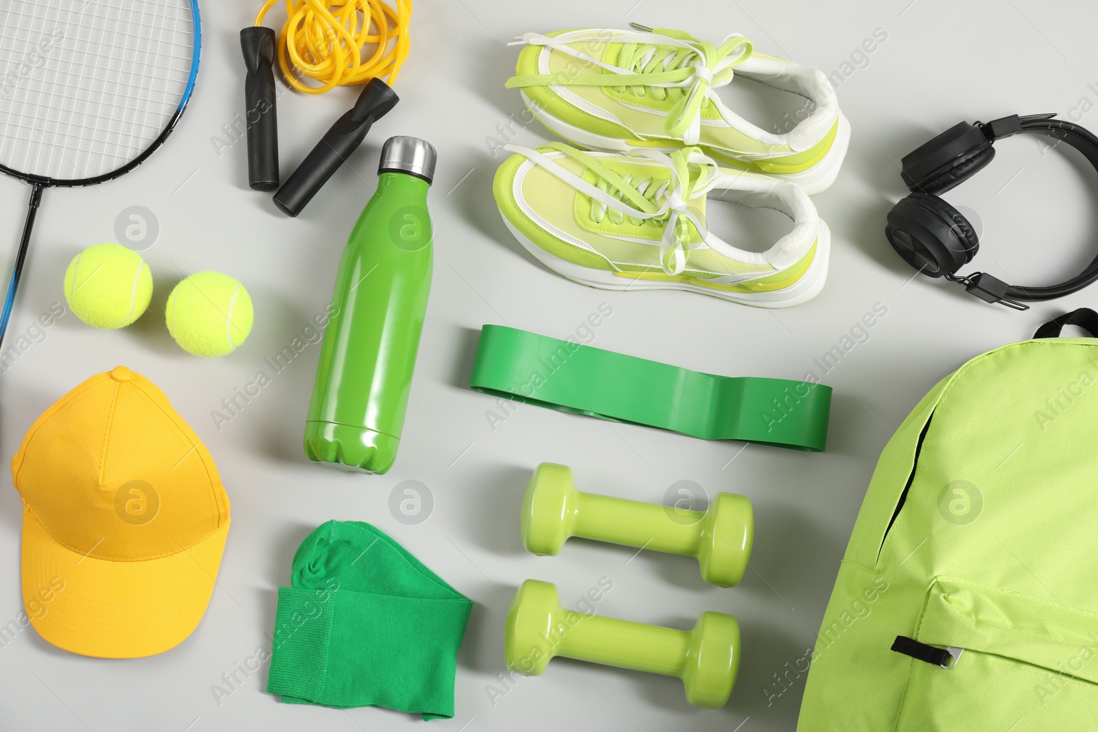 Photo of Different sports equipment on light grey background, flat lay