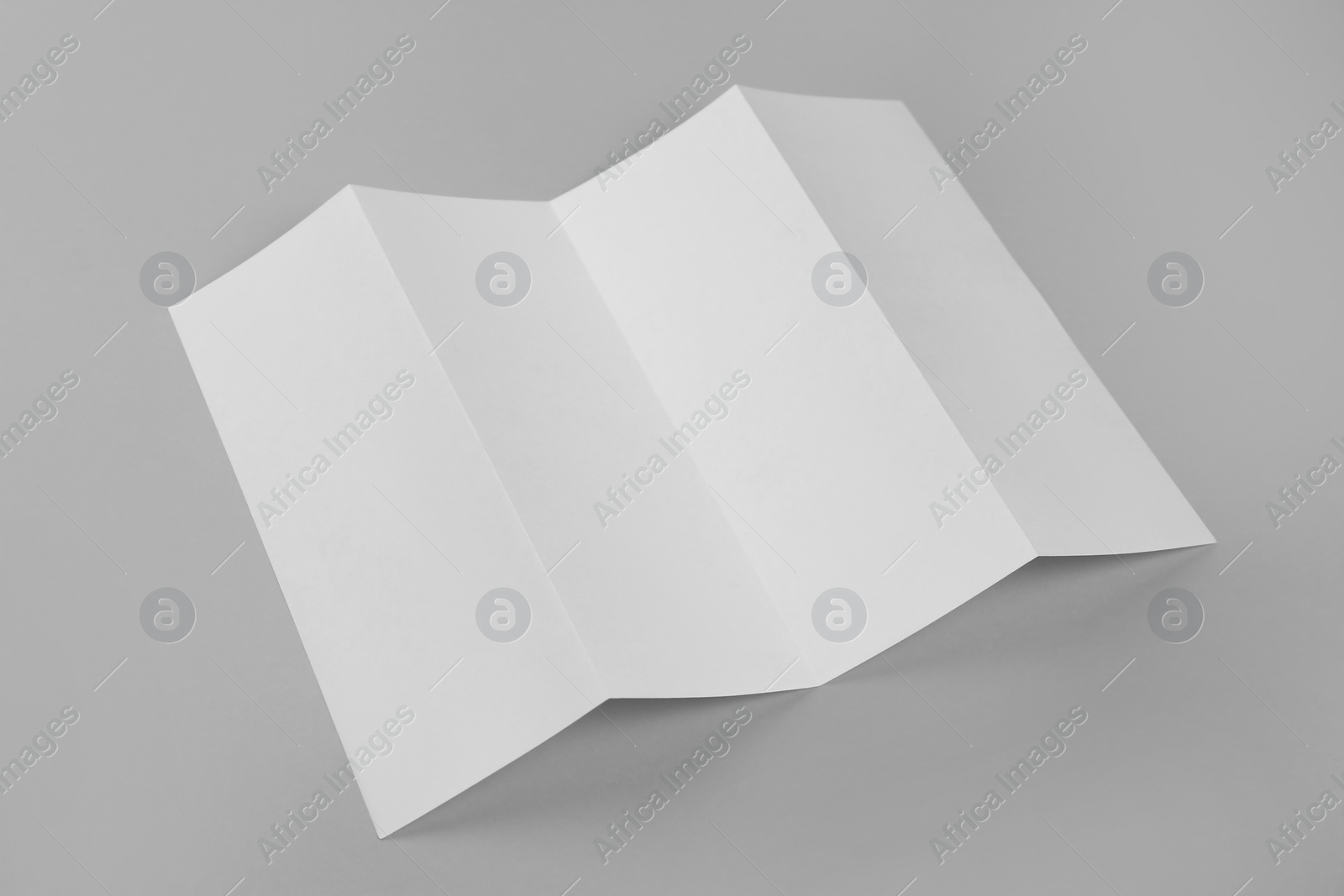 Photo of Blank paper brochure on light grey background. Mockup for design