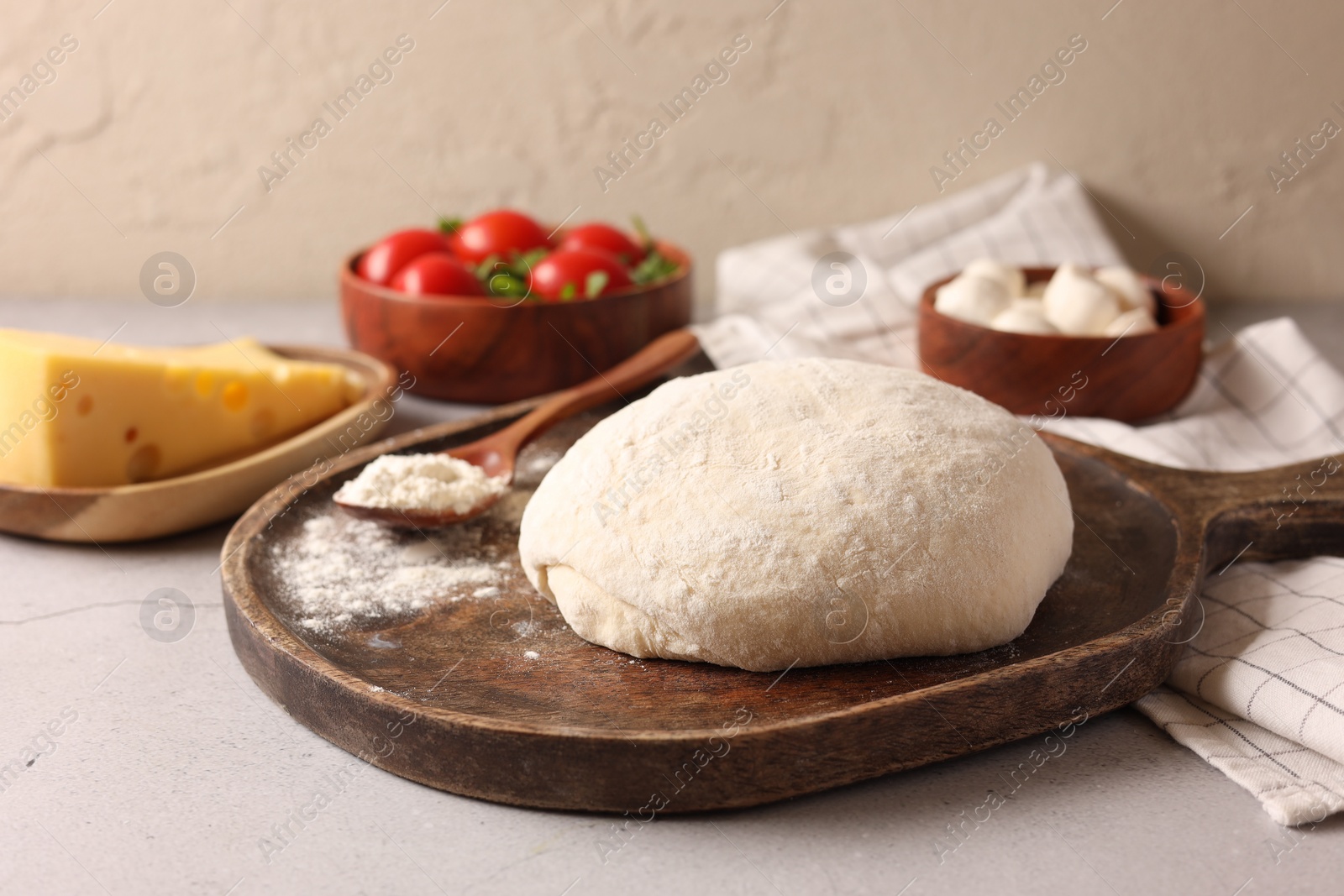 Photo of Pizza dough and products on gray table