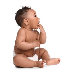 Adorable African-American baby in diaper on white background