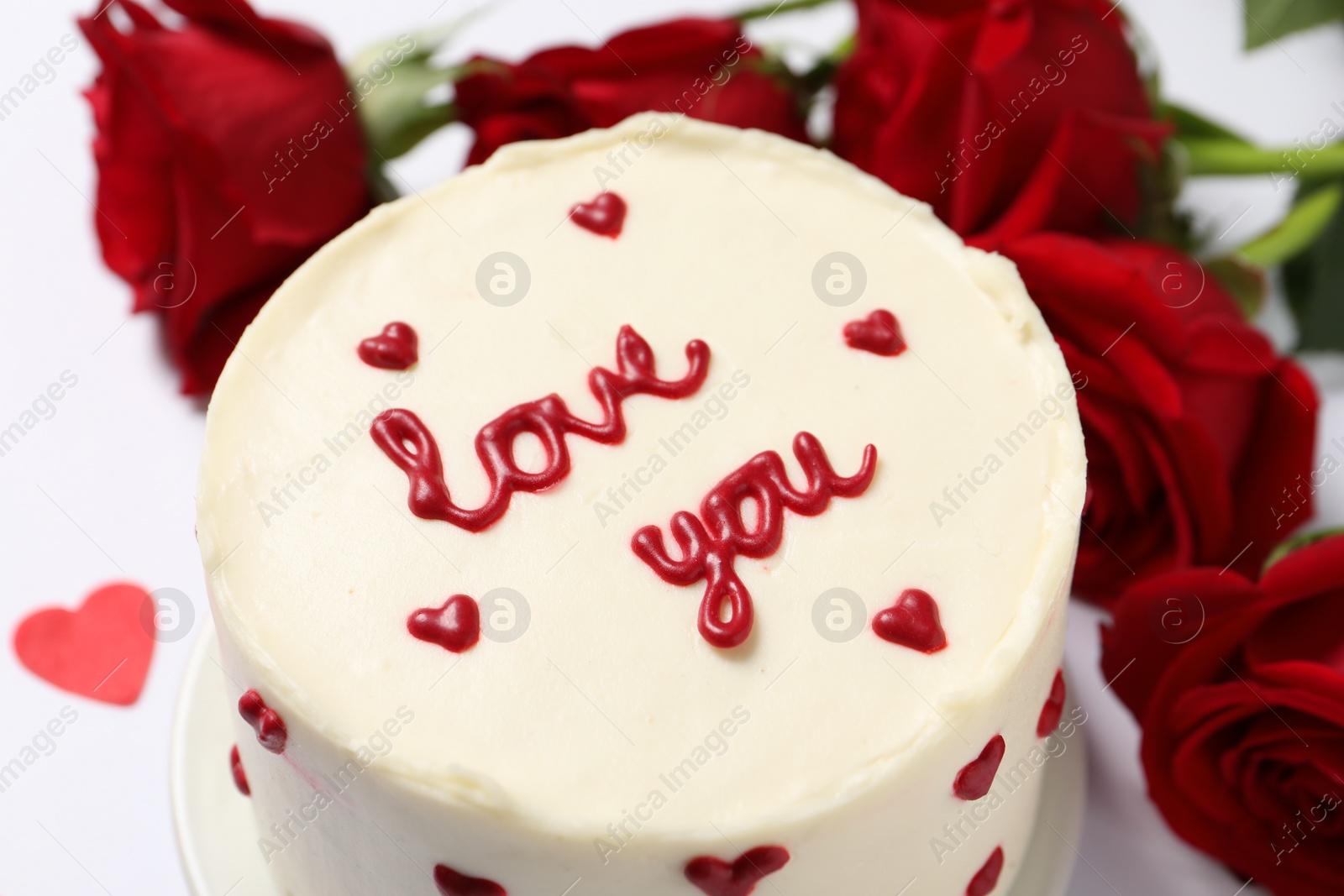 Photo of Bento cake with text Love You and roses on white table, closeup. St. Valentine's day surprise