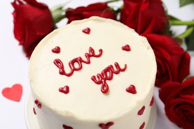 Photo of Bento cake with text Love You and roses on white table, closeup. St. Valentine's day surprise