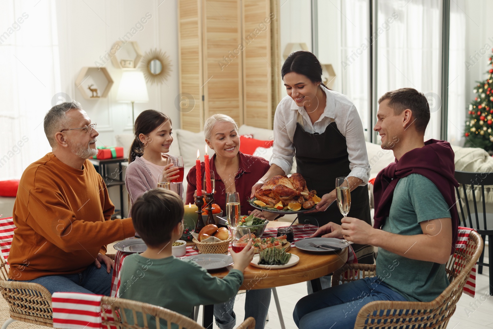 Photo of Happy family enjoying festive dinner at home. Christmas celebration