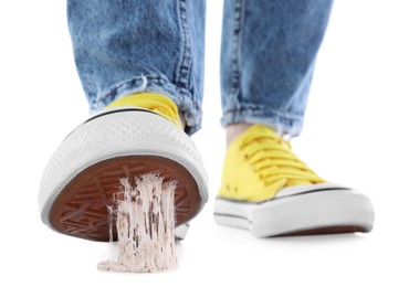 Person stepping into chewing gum on white background, closeup