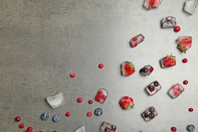 Photo of Frozen berries on gray background, flat lay composition with space for text