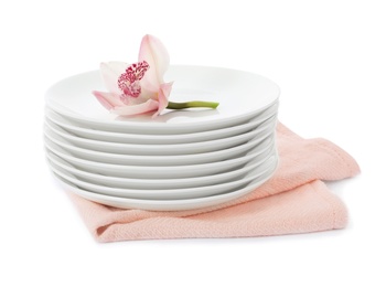 Stack of clean plates with flower on white background. Washing dishes