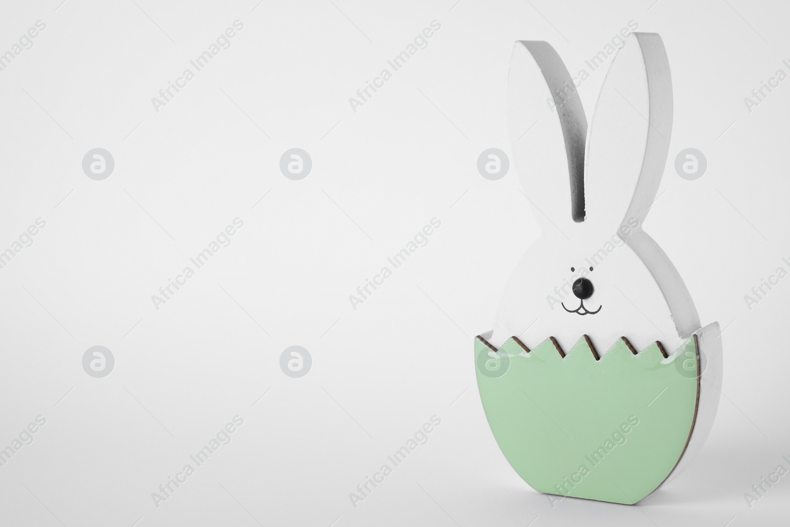 Photo of Easter bunny figure on white background. Space for text