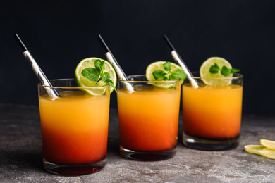 Fresh alcoholic Tequila Sunrise cocktails on grey table