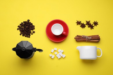 Flat lay composition with roasted beans and geyser coffee maker on yellow background