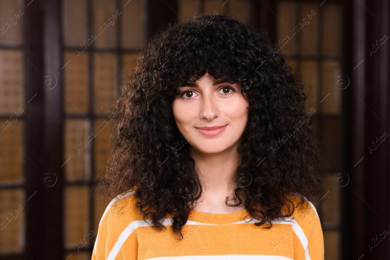 Photo of Portrait of beautiful young woman in stylish sweater indoors