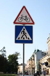 Photo of Traffic signs Pedestrian Crossing and No Bicycles on city street