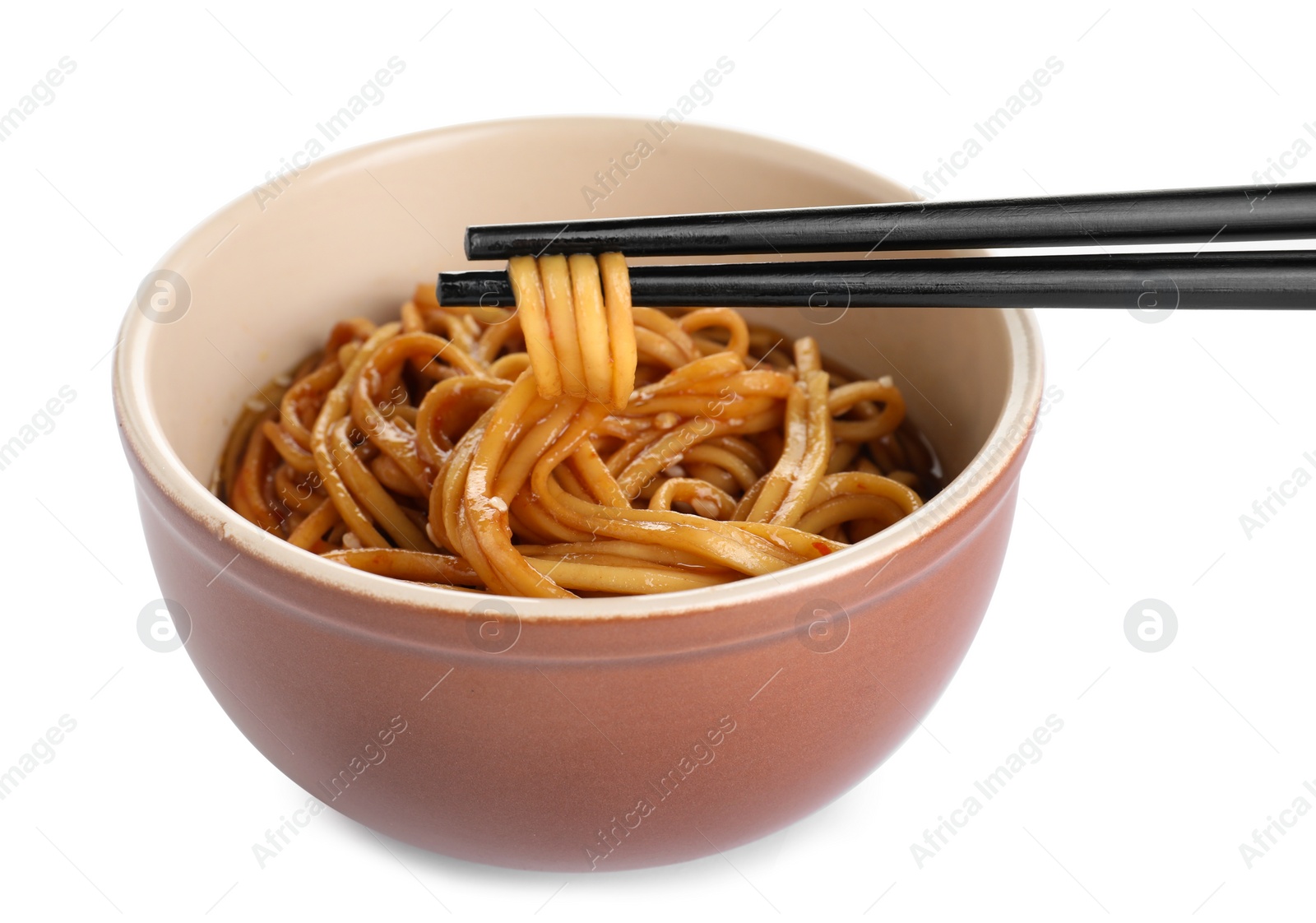 Photo of Chopsticks with tasty cooked noodles over bowl isolated on white