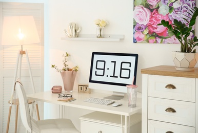 Photo of Comfortable workplace with computer on desk in home office