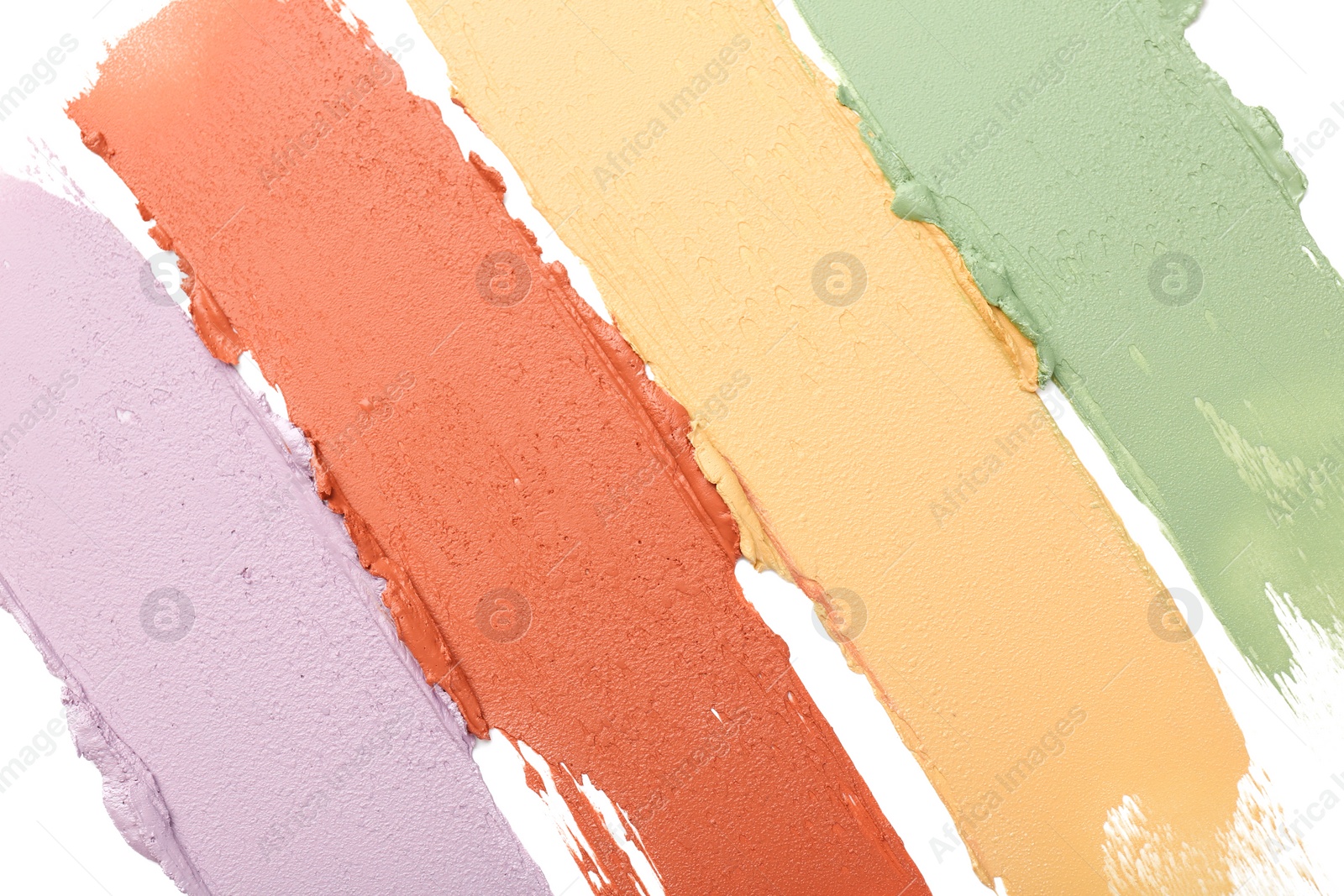 Photo of Samples of color correcting concealers isolated on white, top view