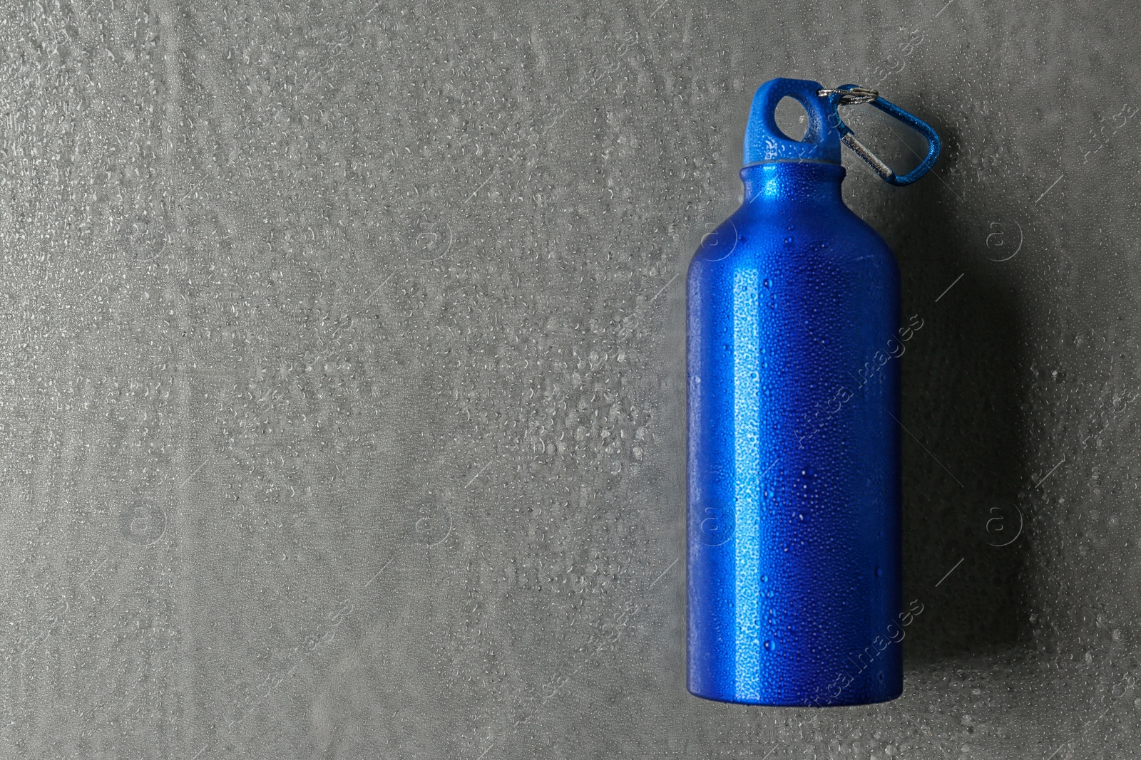 Photo of Aluminum sports water bottle on gray background. Space for text