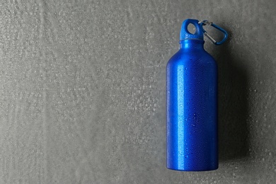 Aluminum sports water bottle on gray background. Space for text