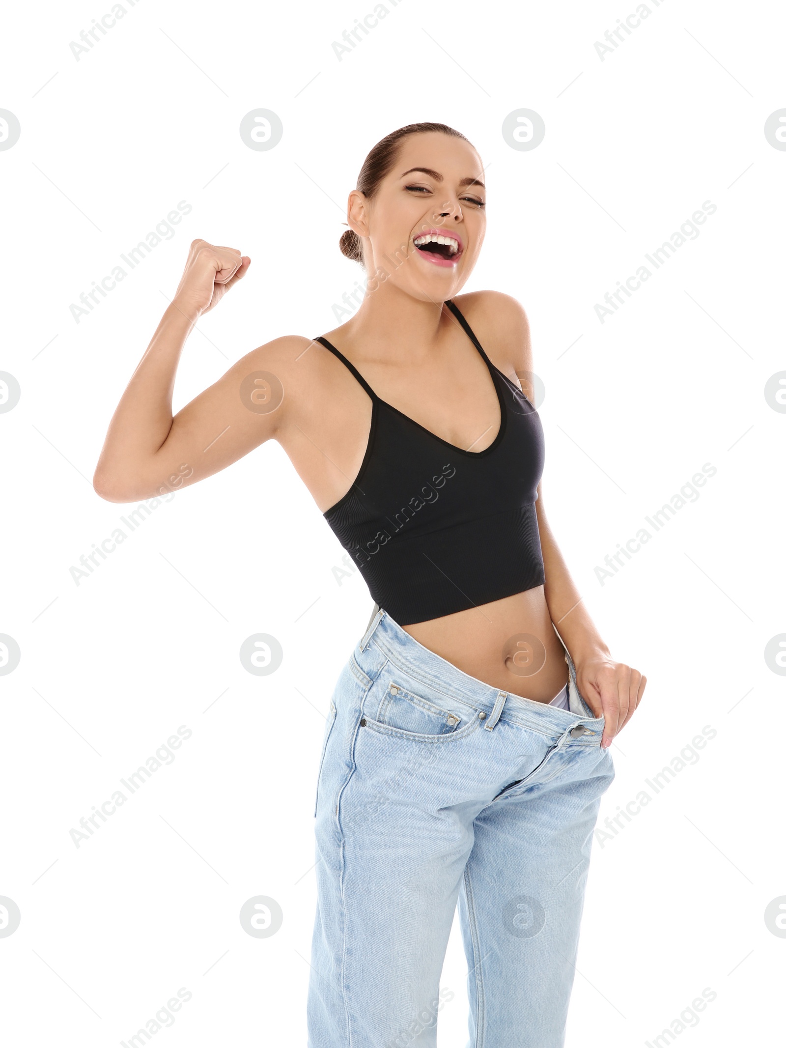 Photo of Slim woman in oversized jeans on white background. Weight loss