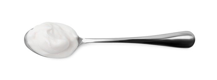 Photo of Delicious natural yogurt in spoon isolated on white, top view