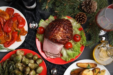 Flat lay composition with delicious ham on black wooden table