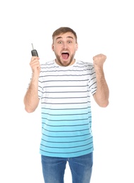 Happy young man with car key on white background. Getting driving license