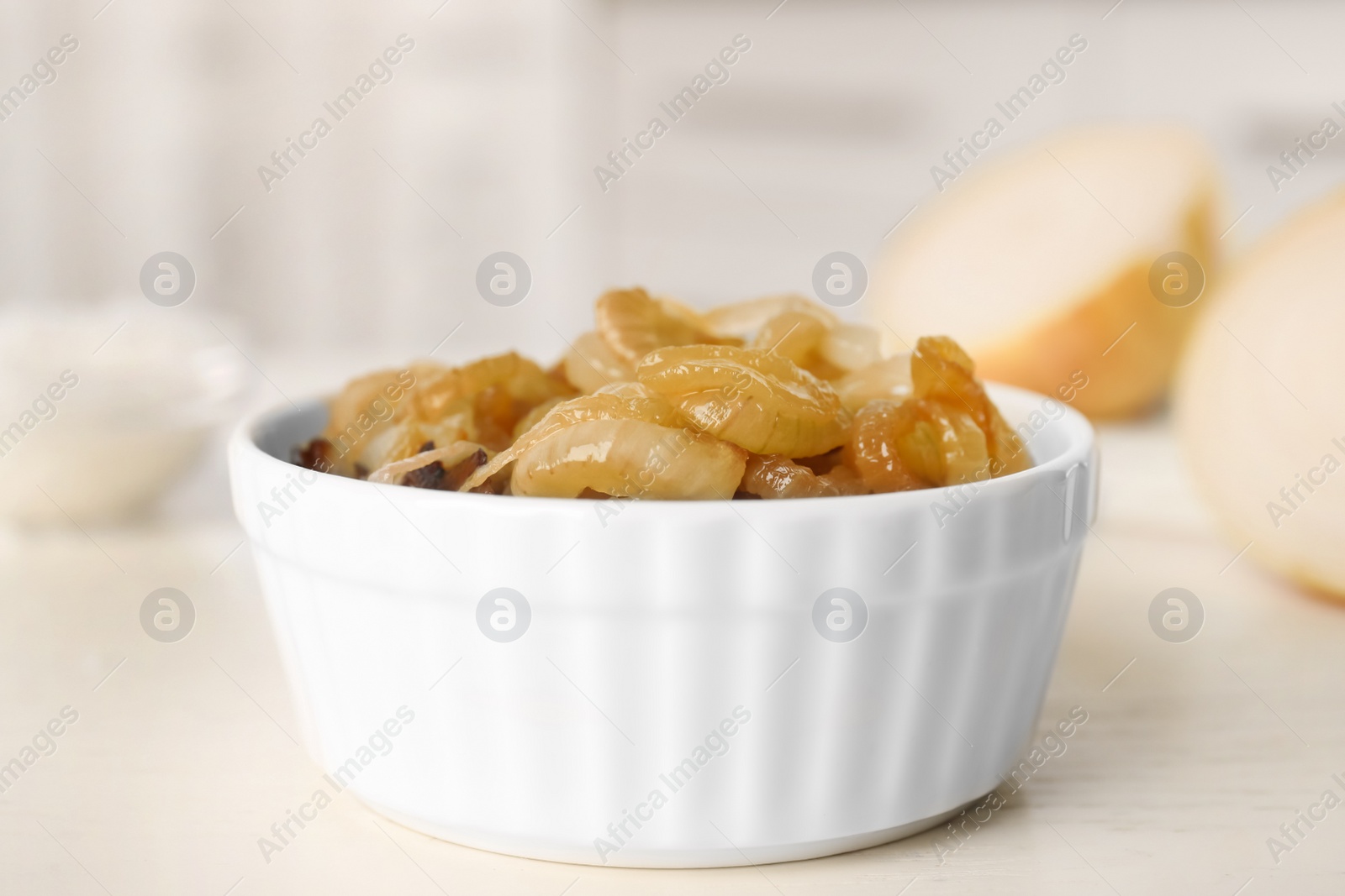 Photo of Tasty fried onion on white table, closeup
