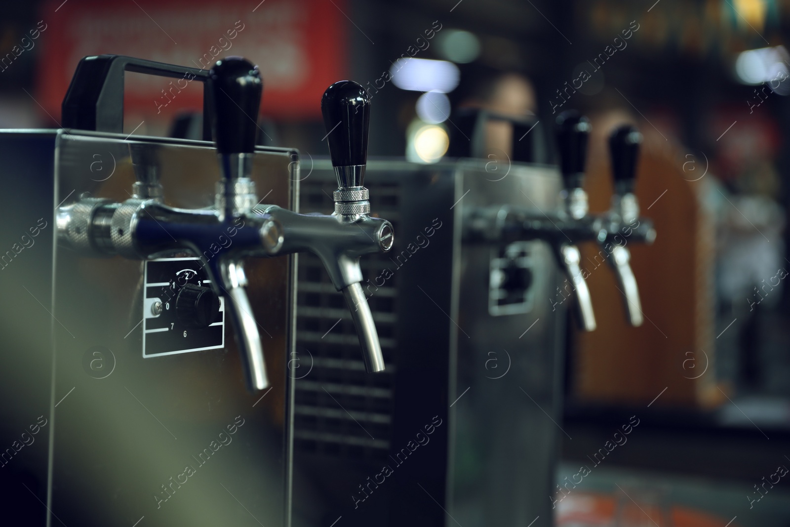 Photo of New modern beer taps on bar counter in pub