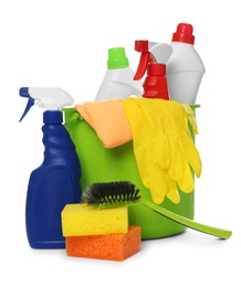 Photo of Bucket with different cleaning products and tools on white background