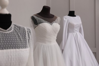 Mannequins with beautiful wedding dresses in atelier