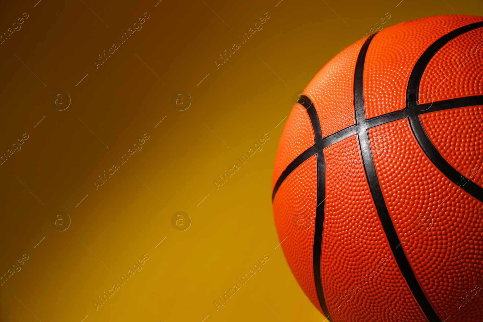 Photo of Basketball ball on color background, closeup. Space for text